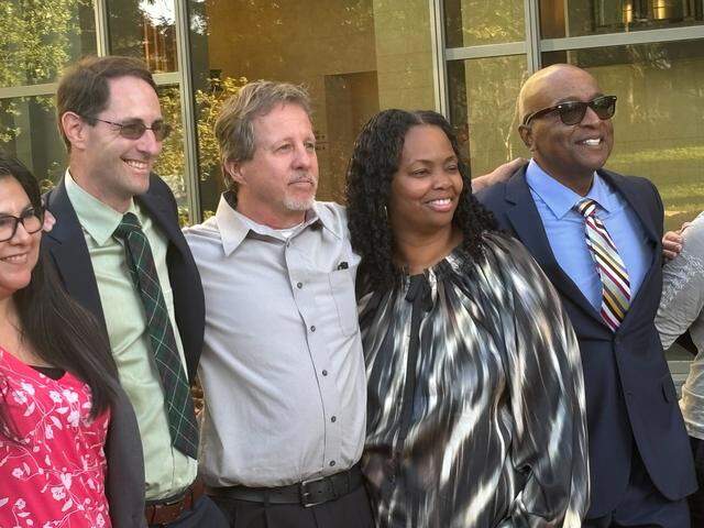 From left: Attorney Kevin Schwin, Charles Smith, La-Kebbia Wilson and George Wilson, La-Kebbia Wilson’s husband, pose outside the courthouse on Wednesday, March 11, 2026, after receiving the verdict of more than $15 million in the hostile work environment case.